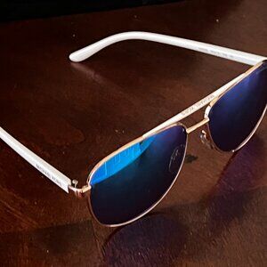 Pair of Michael Kors MK5007 Hvar pilot sunglasses with a rose gold and white fra